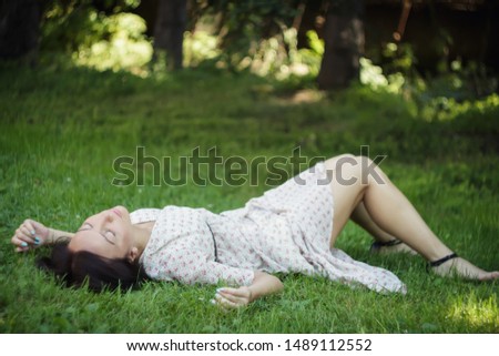 Cute young woman lying on the grass. Soft focus.