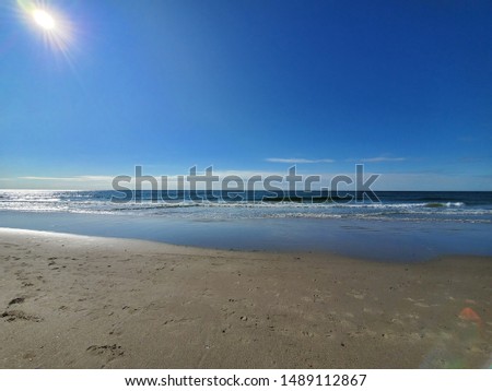 City Beach, Rockaway beach, New York  at sunrise, quiet and empty with a peaceful glow in the background.