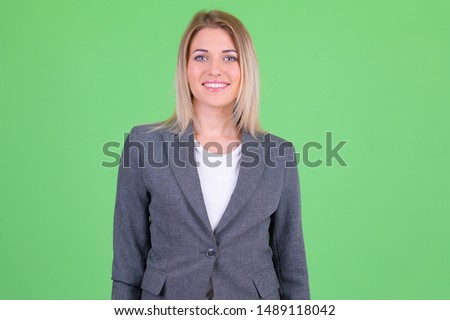 Portrait of happy young beautiful blonde businesswoman smiling