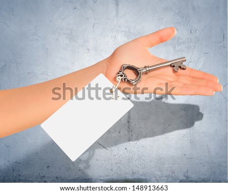 Image of key with blank label in human hand