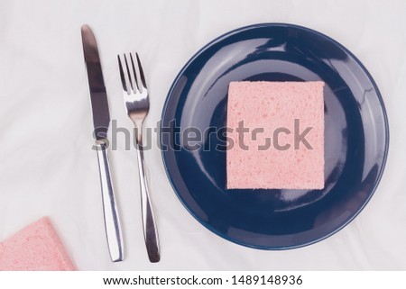 Top view of pink milk flavored sandwich bread on blue plate and white cloth background, soft warm tone, Beautiful breakfast concept.