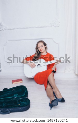 businesswoman earns a living playing the guitar