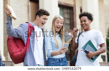 Excellent marks. Surprised students checking exam results online on smartphone Royalty-Free Stock Photo #1489162079