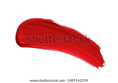Lipstick smear smudge swatch isolated on white background. Cream makeup texture. Bright red color cosmetic product brushstroke swipe sample