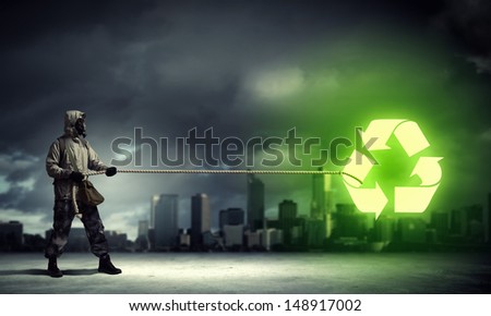 Man in respirator against nuclear background. Recycle concept