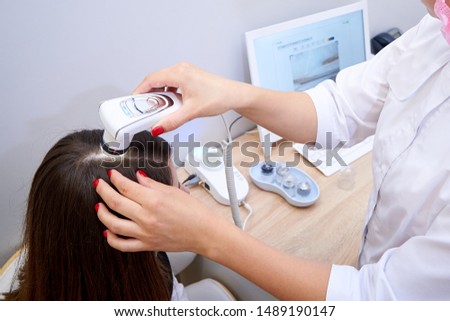 Diagnostic microscopic examination of hair and scalp. Royalty-Free Stock Photo #1489190147