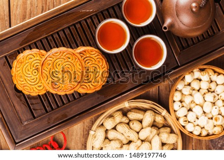 Traditional mooncakes on table setting with teacup.