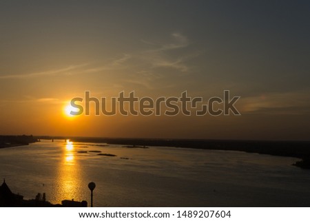 view of the Volga on a summer evening, the picture shows the sunset and reflection on the river