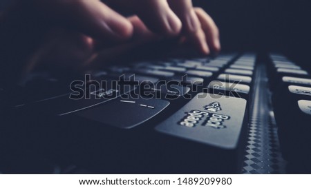 Close-up soft-focus finger typing on keyboard. Man hand using laptop computer in office. Programming and online marketing business concept.