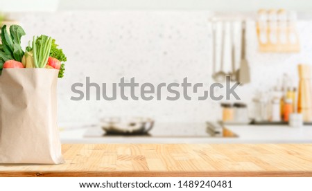 Wood table top on blurred kitchen background Royalty-Free Stock Photo #1489240481