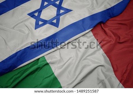 waving colorful flag of italy and national flag of israel. macro