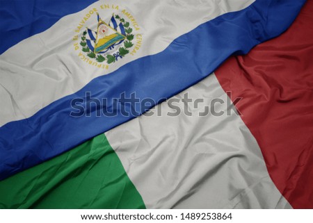 waving colorful flag of italy and national flag of el salvador. macro
