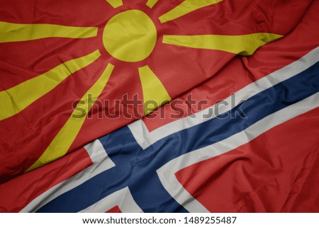 waving colorful flag of norway and national flag of macedonia. macro