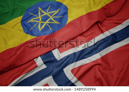 waving colorful flag of norway and national flag of ethiopia. macro