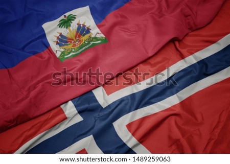 waving colorful flag of norway and national flag of haiti. macro