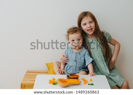 Two sisters at the table with pumpkin