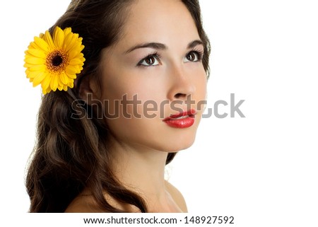 Portrait of young beautiful woman with a gerbera on white background 