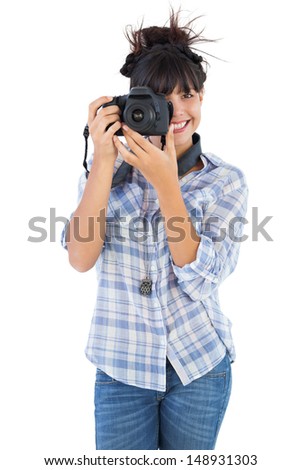 Young woman taking picture with her camera on white background