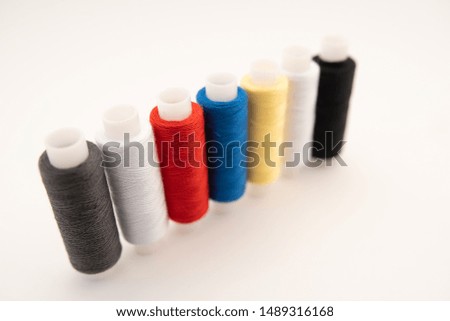 Set of sewing threads beautiful color (blue,yellow, green, white, black) on white background with space for text