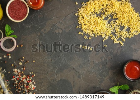 Pasta Alphabet and ingredient for sauce (set of ingredients, raw pasta) serving second course. top food background. copy space
