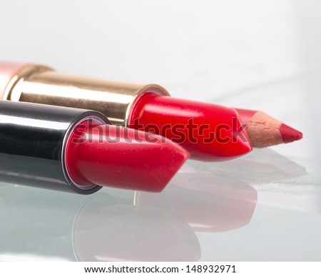 two red lipsticks vertical close up picture