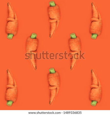 Carrot pattern on orange background made of photography, top view. Vegetables raw, vegan, ugly food concept, flatlay. Abstract wallpaper.