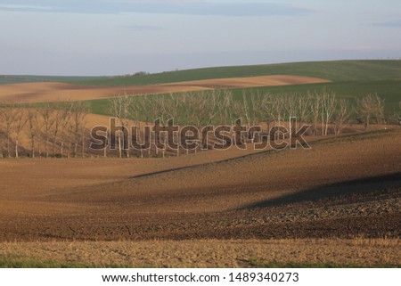 Background landscape with agricultural fields on spring hills. South Moravia, Czech Republic.