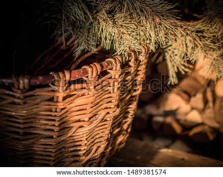 wicker basket handmade with fir branches, illuminated by the sun. Rustic style