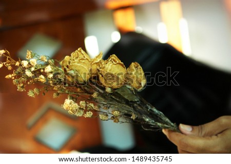 Wedding bouquet in hands of bride and groom