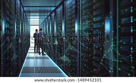 IT Engineers and Technician discussing technical problem in server room with data connection visual effect . Royalty-Free Stock Photo #1489452101