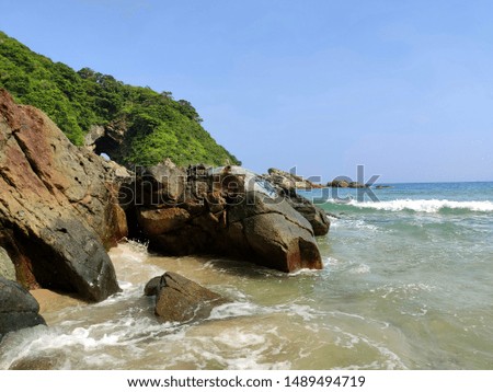 Spectacular Dong Chong beach with clean turquoise water and big enough waves for surfing and diving. Green and beautiful hills and caves around. Shenzhen, China.