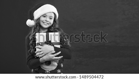 New year party. Santa claus kid. Little girl child in santa red hat. Christmas shopping. Happy winter holidays. Small girl. Present for Xmas. Childhood. Happy New Year. copy space