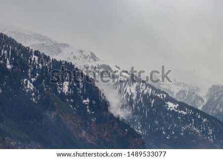 Snow at hills with tree and sky image is taken at manali india showing it amazing natural view.