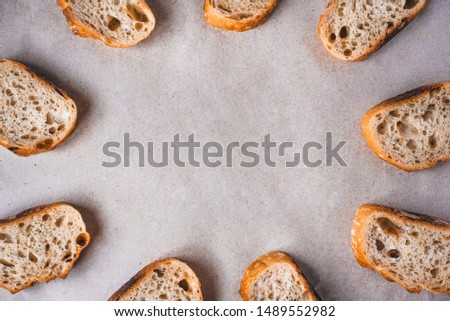 Pattern with pieces of white bread on paper background. Top view. Copy space.