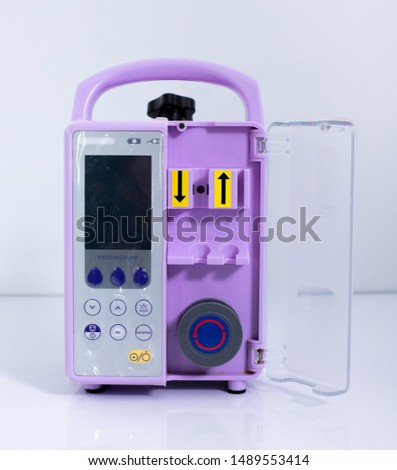 Feeding Pump medical device purple color to supplement nutrition liquid food to tube Enteral feeding fluid set bag Royalty-Free Stock Photo #1489553414