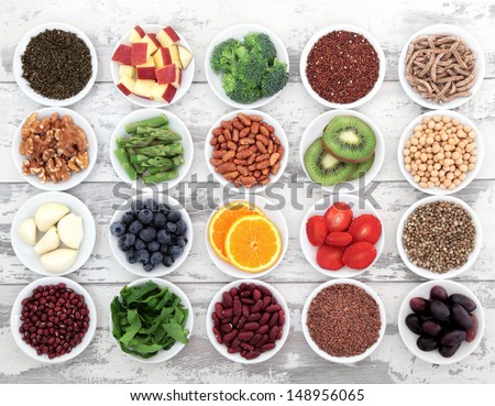 Large super food selection in white porcelain dishes over distressed white wooden background. Royalty-Free Stock Photo #148956065
