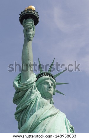 Statue of Liberty on Liberty Island in New York City. - isolated on blue background 