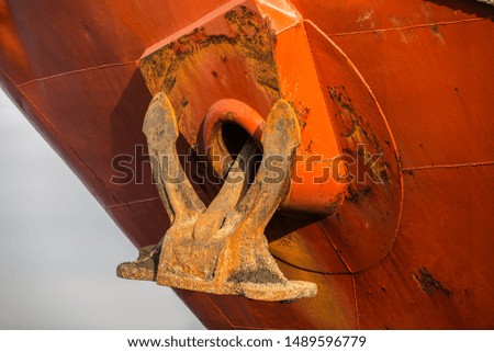An old rusty ship anchor.