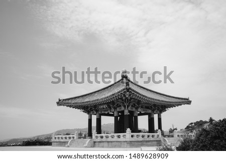 Pagoda in California against the blue sky. Authentic asian building with curved rooftop and colorful decorations. Chinese rooftop against the cloudy blue sky. Asian background.