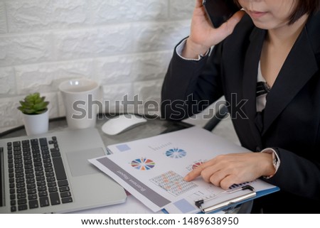 Business woman investment consultant analyzing company annual financial report balance statement working with documents graphics, Concept picture of economy,project, office,money and tax.
