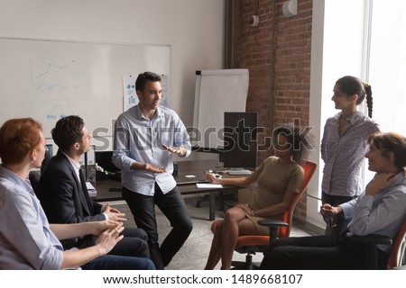 Diverse employees brainstorm share ideas at casual office meeting in coworking workspace, multiracial colleagues talk discuss projects together cooperating at informal briefing. Collaboration concept