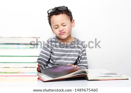 child reading book at school been educated on white background stock images stock photo