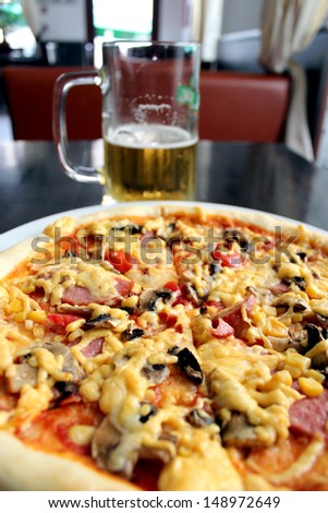image of tasty pizza with glass of beer