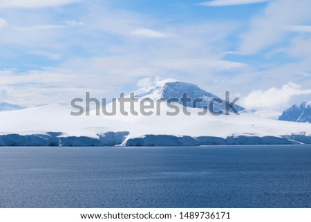 Landscape of snowy mountains and frozen coasts along the Danco Coast in the Antarctic Peninsula, Antarctica