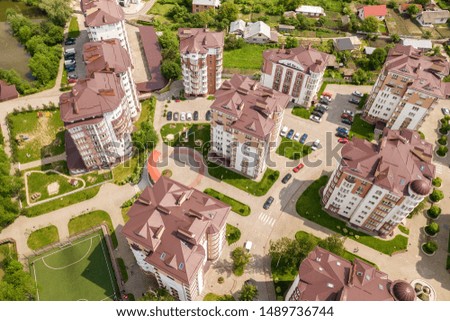 Top view of apartment or office tall buildings, parked cars, urban city landscape. Drone aerial photography.