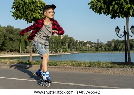 Boy with blue roller blades in park