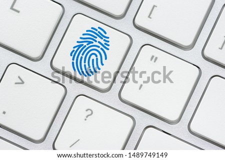 Biometric authentication and access control, security concept : Fringerprint symbol on a surface of a white keyboard, fingerprint is an impression left by friction ridge of human finger, it is unique