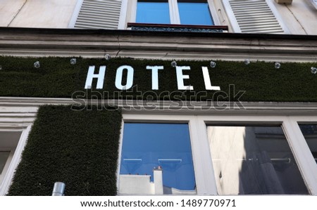 Old facade with hotel sign.