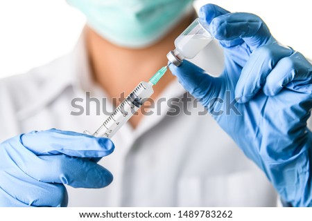 Doctor, nurse, scientist hand in blue gloves holding flu, measles, coronavirus, covid-19 vaccine disease preparing for child, baby, adult, man and woman vaccination shot, medicine and drug concept. Royalty-Free Stock Photo #1489783262