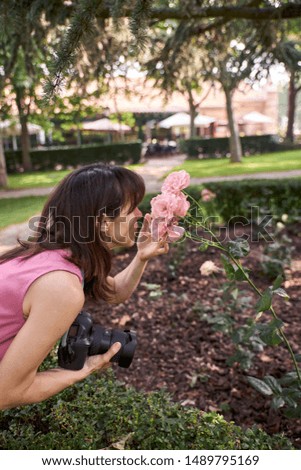 view of a woman photographing a beautiful flowers